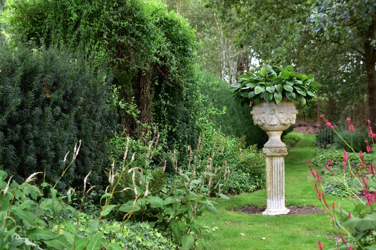 Gepflegter grüner Garten mit geschnittenen Hecken und Beeten